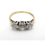A 9ct gold ring set with trio of cubic zirconia to top. Ring size approx P 1/2 Please Note - we do