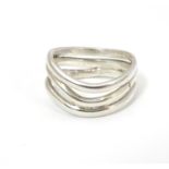 A silver ring formed as three joined wavy strands. Hallmarked London 2017, maker Amanda Birkett.