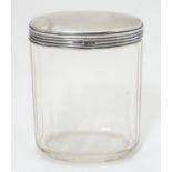 A glass dressing table jar with silver top. Hallmarked London 1914 maker Wolfsky & Co Ltd. 3 1/2"