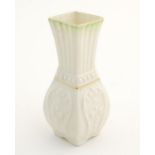 A small Belleek bud vase of squared form with fluted neck and relief decoration. Approx. 4" high.