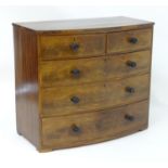 A Victorian mahogany bow fronted chest of drawers comprising two short over three long drawers