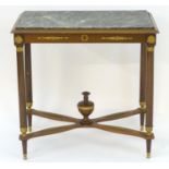 A French Empire mahogany table with a rectangular marble top above applied gilt decorations, the