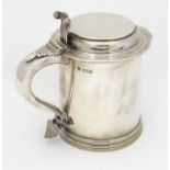 A Victorian silver lidded tankard, with flat lid, scrolling handle with heart formed terminal.