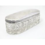 A cut glass dressing table pot with silver top hallmarked London 1919 maker JE. 4 1/4" long Please