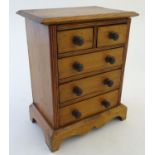 An early 20thC pine apprentice piece / miniature chest of drawers, two over three drawers. Approx.