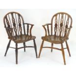 Two early / mid 19thC yew wood draught back Windsor chairs, with bowed backs and three carved back