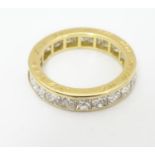 An 18ct gold eternity ring set with 22 Princess cut diamonds. Each diamond approx 3.5mm wide. Ring