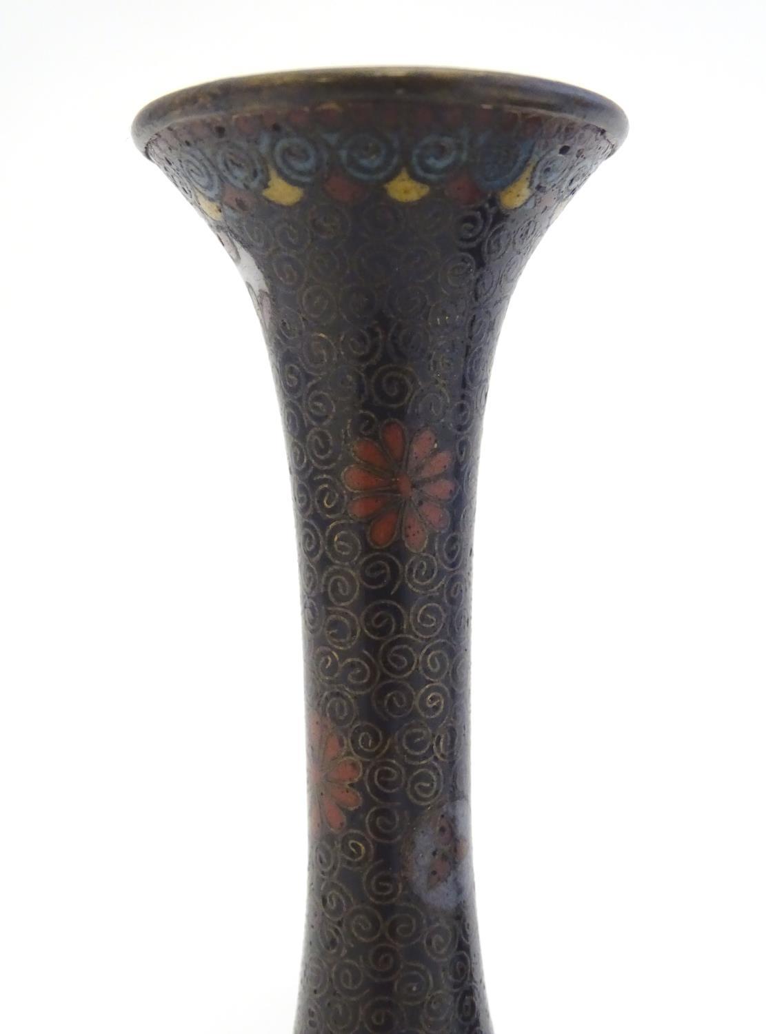 A pair of early 20thC cloisonne bottle vases with elongated necks and flared rims, with floral - Image 6 of 9