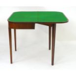 An early 19thC mahogany card table with satinwood stringing and raised on tapering squared legs. 36"