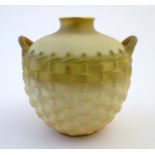 A Royal Worcester ivory ground pot formed as an osier-work twin handled basket with gilt and blush