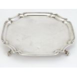 A silver waiter / card tray on four scrolling feet. Hallmarked Birmingham 1971 maker J B