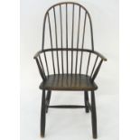 A late 19thC double bow back Windsor chair raised on turned tapering legs united by a H stretcher.