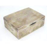 A silver table top cigarette box with wood lined interior. Hallmarked Birmingham 1908 maker A & J