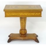 A 19thC and later Irish Killarney style games table with a marquetry inlaid and decoratively