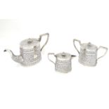 A three piece white metal tea set comprising teapot, lidded milk jug and lidded sugar. with acanthus