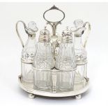 A Geo III silver cruet stand hallmarked London 1806 with 5 cut glass cruet bottles. The whole