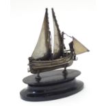 A Maltese silver model of a sailing boat, mounted on an ebonised base. The whole 4 1/2" high