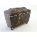 A 19thC tortoiseshell tea caddy of sarcophagus form tih a hinged lid and two lidded sections within.