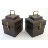 A pair of tin boxes / caddies, each with a hinged lid, handle and catch. Approx. 7 1/2'' tall. (2)