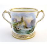 A late 19thC Coalport loving cup decorated with a hand painted coastal scene with a shipwreck by a