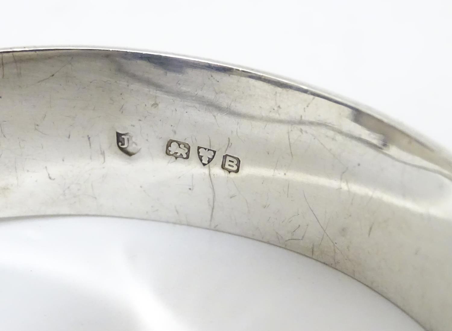 A silver bracelet of bangle form with engraved acanthus scroll decoration. Hallmrked Chester 1952 - Image 7 of 8