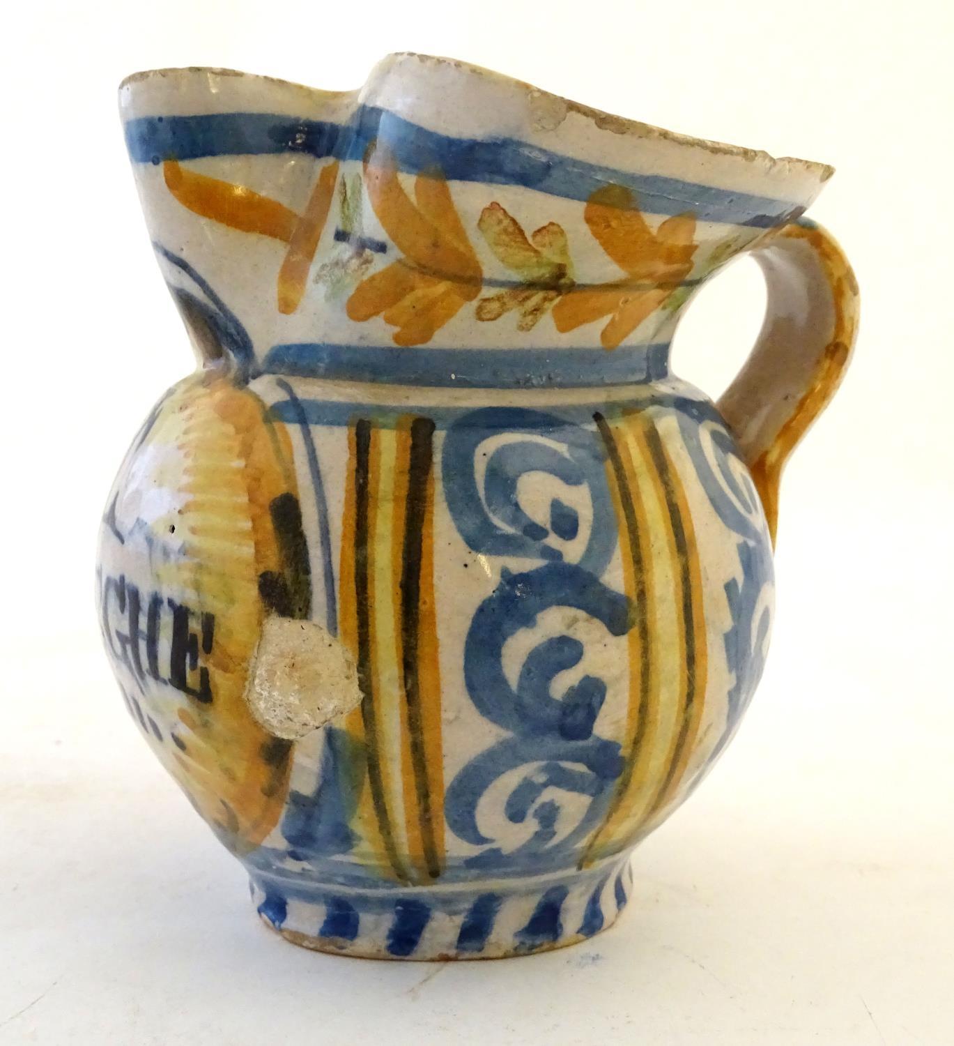 A 19thC Continental faience / tin glaze jug with a pinch spout, decorated with a roundel inscribed - Image 3 of 10