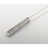 A 9ct white gold necklace and pendant, the pendant set with 12 linear set diamonds. 18" long
