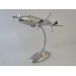 A large Art Deco four-engined aeroplane model, of aluminium construction with stand. 24" long, 28"