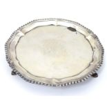 A Geo III Scottish silver waiter / salver with gadrooned border and three feet. With engraved Clan