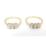 Two 10ct gold rings each set with trio of white stones. Ring sizes approx size O and size R (2)