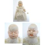 Toy: A bisque doll with two faces: one sleeping and one crying, with articulated arms and legs,
