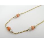 A 9ct gold necklace set with pearl an coral beads. Approx 16" long Please Note - we do not make