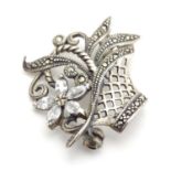 A silver brooch with marcasite and white stone detail. 1" in diameter Please Note - we do not make