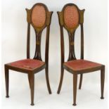 A pair of early 20thC Art Nouveau chairs with shaped and upholstered backrests, pierced back