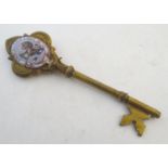 A 19thC brass presentation key with enamel detail depicting a lion holding a key with the Latin