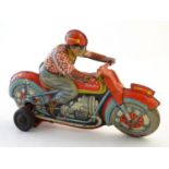 Toy: A Technofix tin clockwork motorcycle and racer. The wheel is marked Metzeler Cord 25 x 9.