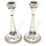 A pair of silver candlesticks with turquoise coloured cabochon decoration. Marked 925 made in