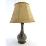 Lighting: an early-to-mid 20thC Oriental table lamp, with brass fitments and base, the ceramic