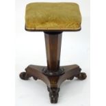 A William IV rosewood piano stool with a squared top above a triform canted pedestal base and