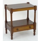 An early 19thC mahogany whatnot / trolley with a rectangular top above turned supports and a
