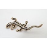 A vintage brooch formed as a lizard, the eyes and back line detailed with white stones. Approx. 2?
