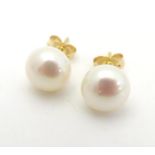A pair of 14ct gold pearl stud earrings. Please Note - we do not make reference to the condition