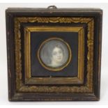 A 19thC English School circular watercolour and bodycolour portrait miniature depicting the head