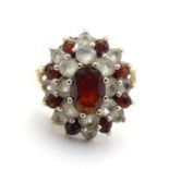 A 9ct gold ring set with red and white stones. ring size approx size L. Please Note - we do not make