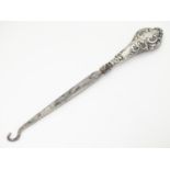 A silver handled button hook 7" long Please Note - we do not make reference to the condition of lots