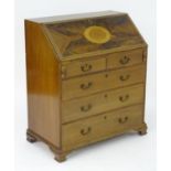 A late 19thC mahogany bureau with an inlaid, crossbanded fall front opening to show a fitted