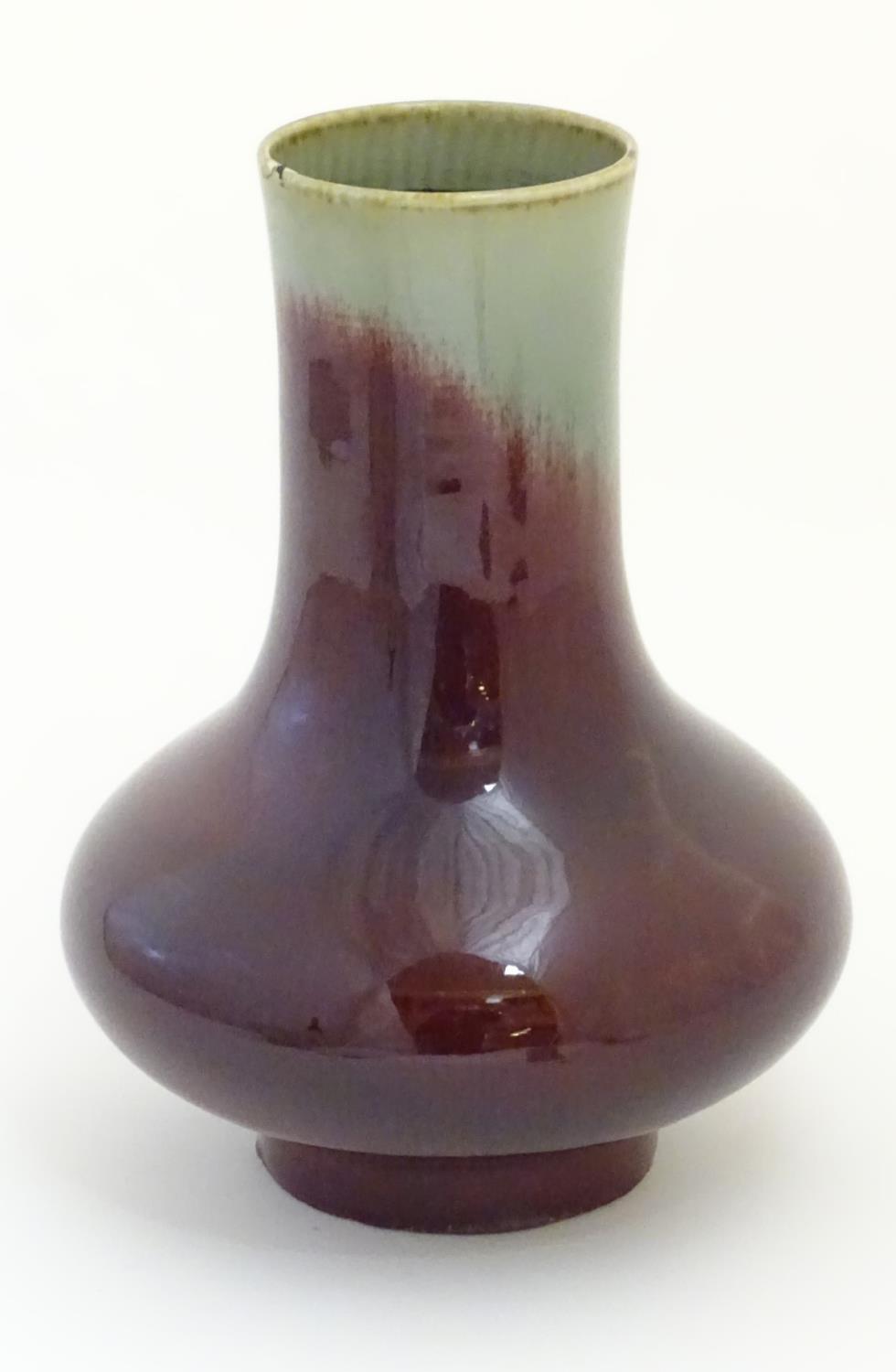 A Chinese sang de boeuf two tone vase with a crackle glaze. Character marks under. 11 1/2'' high. - Image 3 of 5