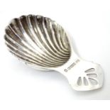 A silver caddy spoon with shell formed bowl, hallmarked Birmingham 1977, with silver jubilee mark,