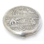 A Sterling silver compact depicting figure and elephant etc. possibly Indian. 3" diameter Please