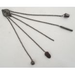 A 19thC cut steel 5 chain chatelaine with acorn shaped pin holder, tape measure, needle holder and